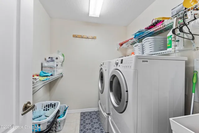 a view of a dining room with furniture and a chandelier