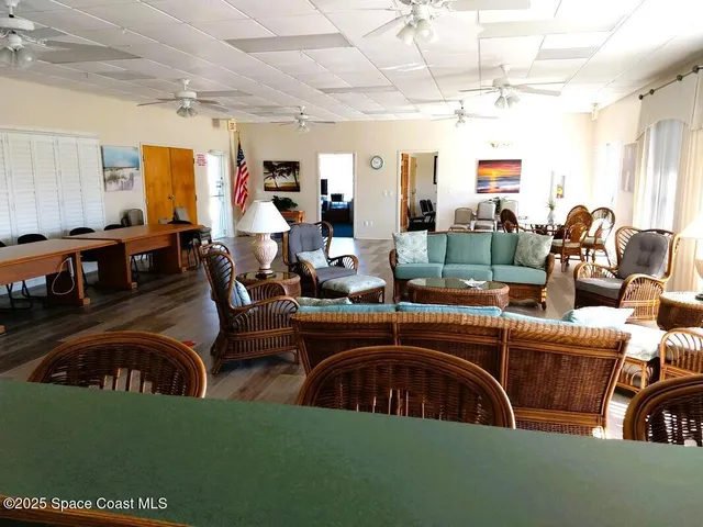 a view of a swimming pool with lawn chairs and a big yard