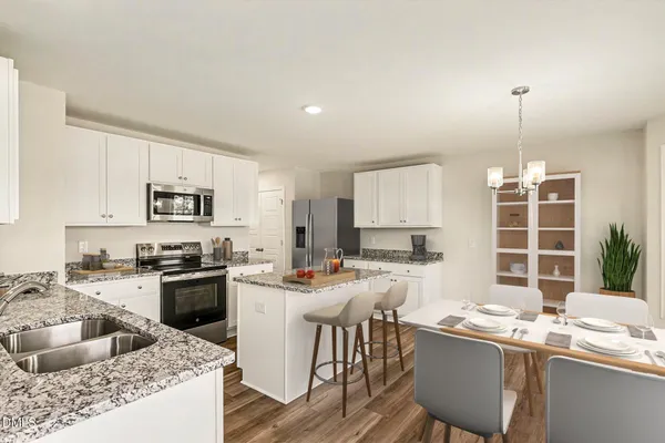 a kitchen with granite countertop a sink stove and cabinets