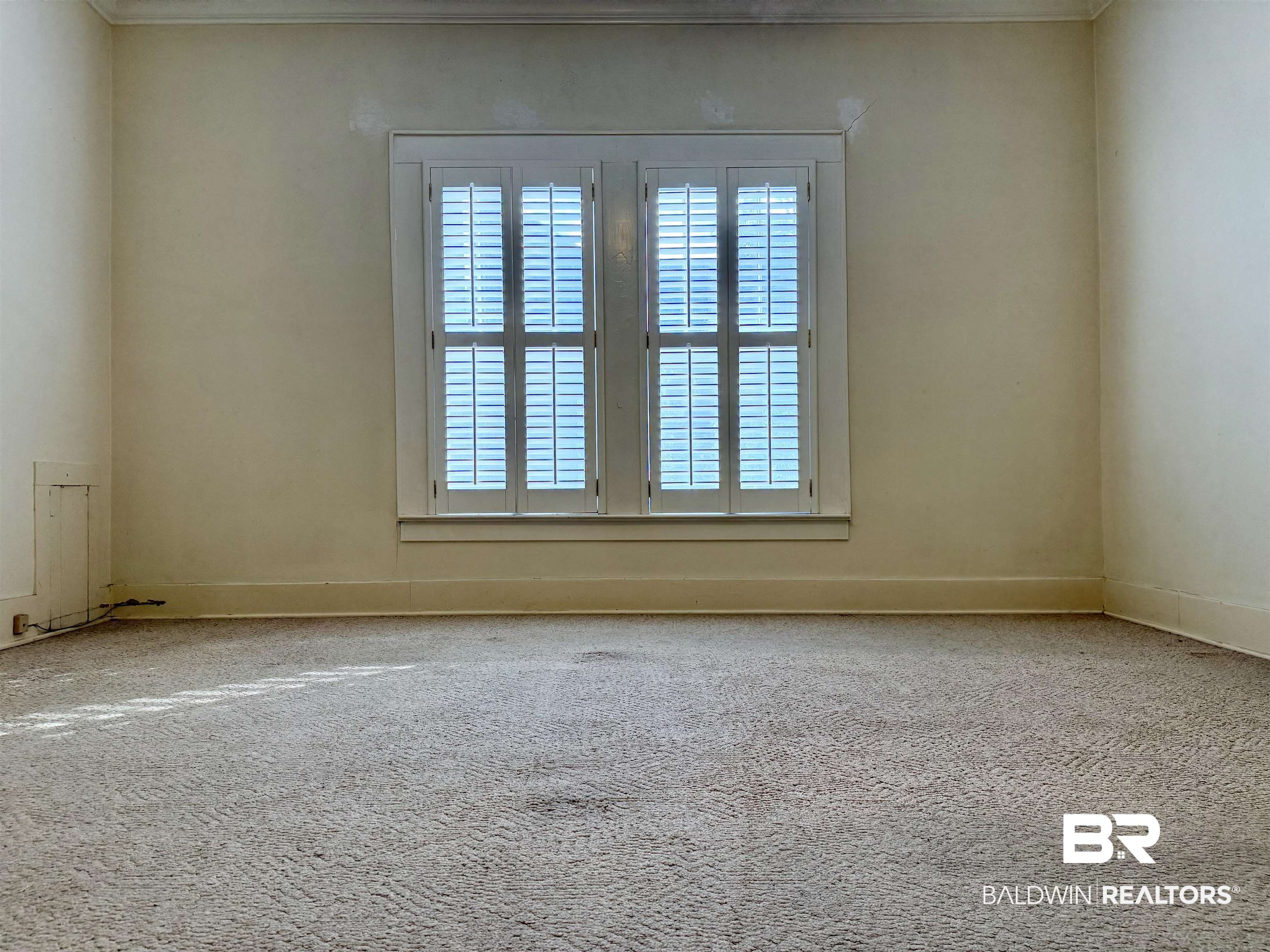423 Evergreen Avenue Brewton, AL 36426 - Photo 15 of 18 Spare room featuring carpet and baseboards