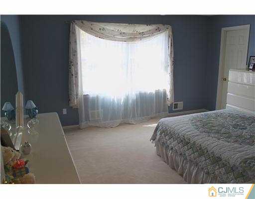 56 Pennington Road New Brunswick, NJ 08901 - Photo 14 of 20 a bedroom with a bed and a window