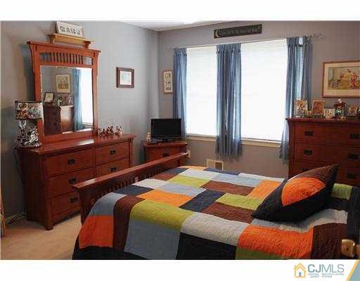 56 Pennington Road New Brunswick, NJ 08901 - Photo 15 of 20 a bedroom with a bed and a dresser