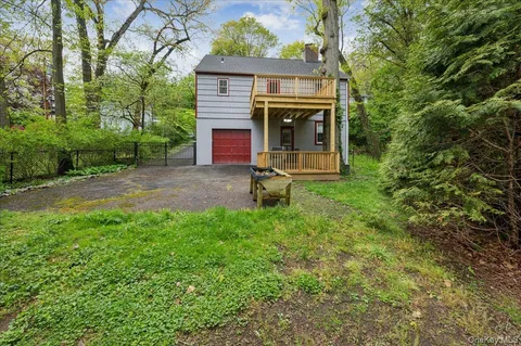 a view of backyard with table and chairs and a fire pit