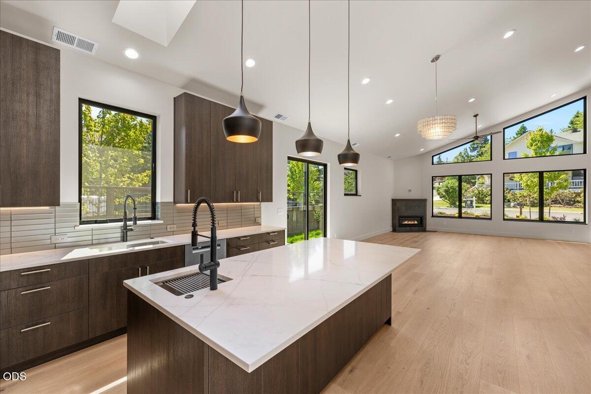 391 Clinton Street Ashland, OR 97520 - Photo 18 of 41 a kitchen with kitchen island a large counter top space appliances and a sink