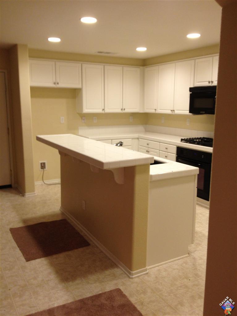 38217 Rioja Court Palmdale, CA 93550 - Photo 3 of 14 a view of kitchen with granite countertop cabinets and sink