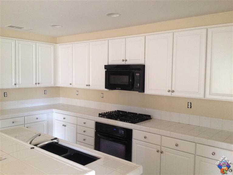 38217 Rioja Court Palmdale, CA 93550 - Photo 4 of 14 a kitchen with granite countertop white cabinets and stainless steel appliances
