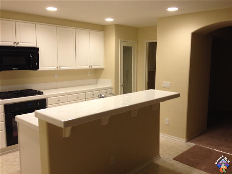 38217 Rioja Court Palmdale, CA 93550 - Photo 5 of 14 a kitchen with a sink a stove and a refrigerator