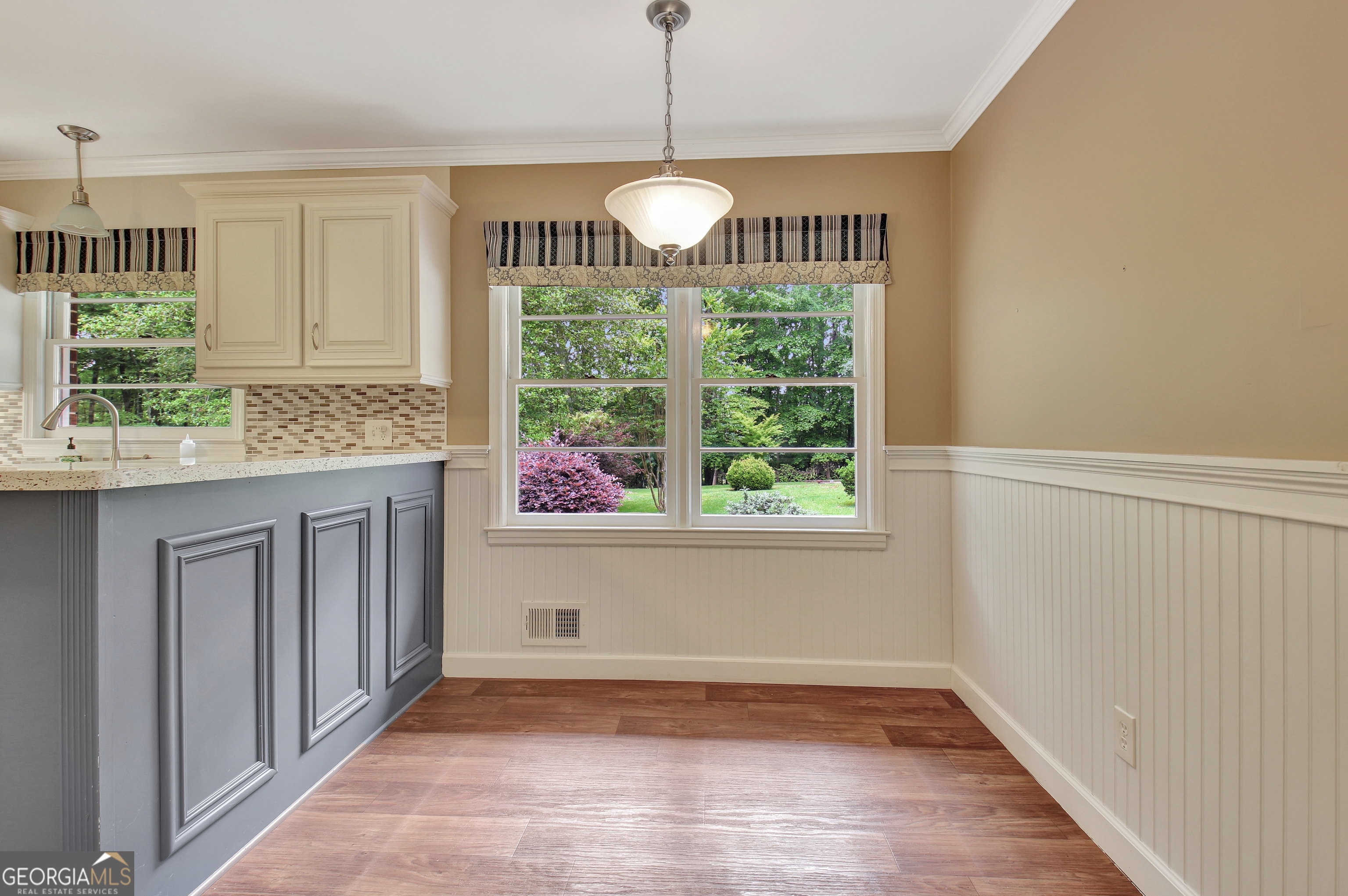 717 Tyrone Road Tyrone, GA 30290 - Photo 35 of 58 a view of a room with wooden floor chandeliers and kitchen view