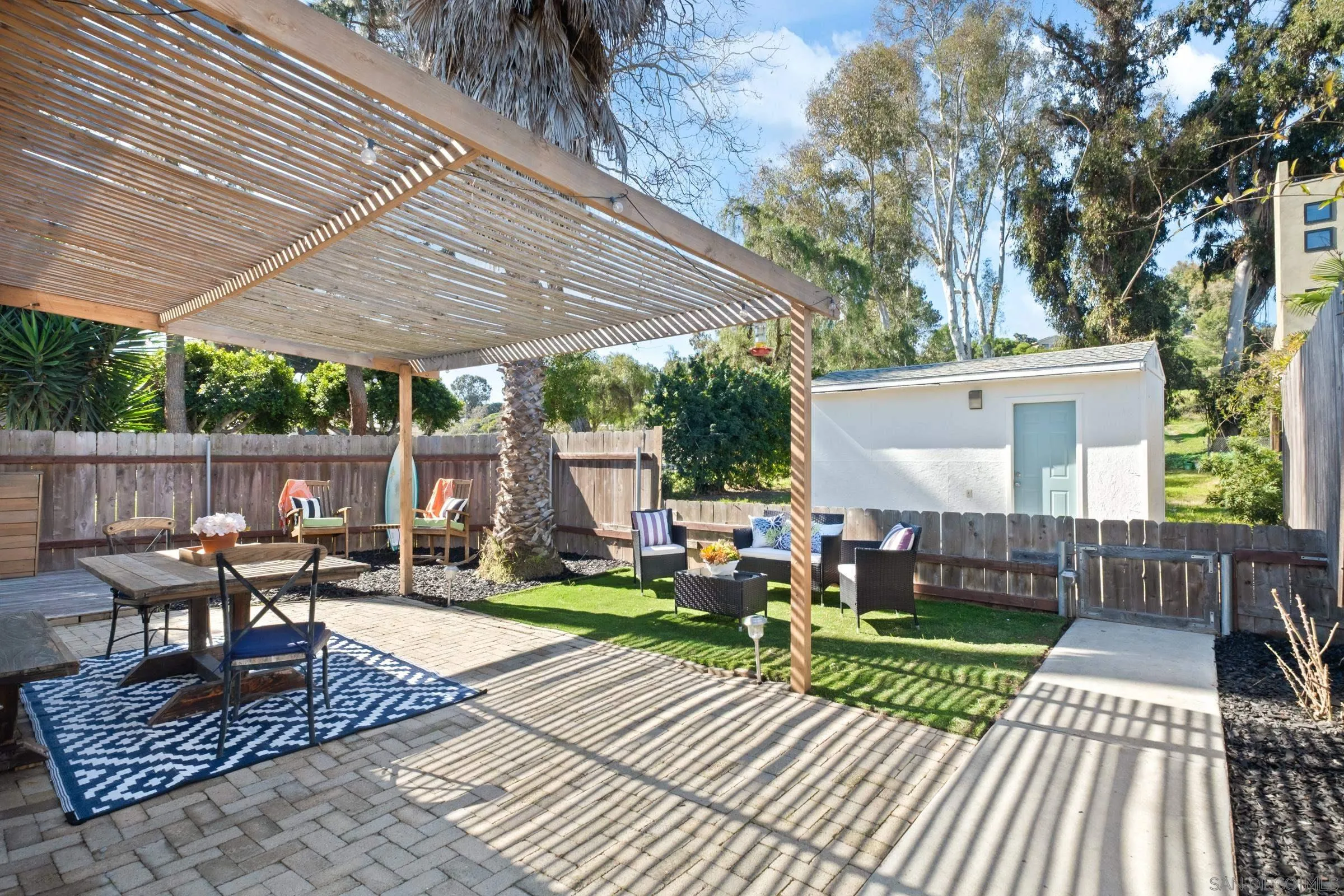 701 Valley Avenue Solana Beach, CA 92075 - Photo 14 of 38 a view of a patio with a table chairs and a yard