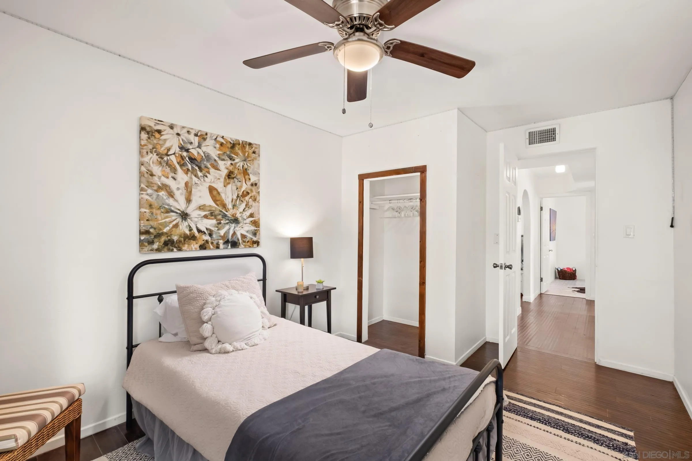 701 Valley Avenue Solana Beach, CA 92075 - Photo 35 of 38 a bedroom with a bed and a chandelier