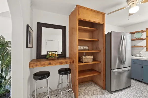 a kitchen with a refrigerator and more cabinets