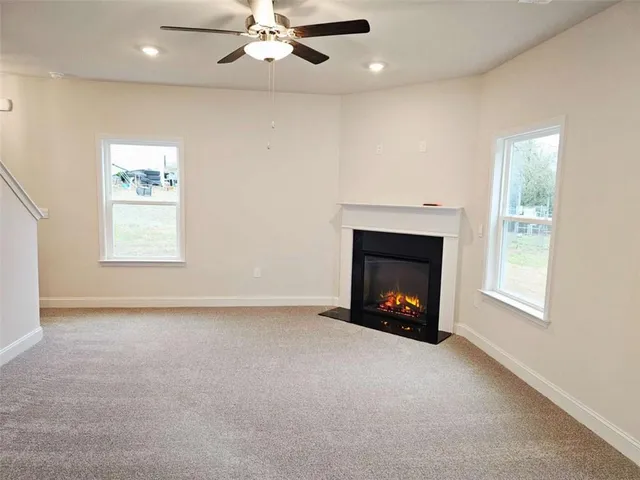 an empty room with fireplace and window