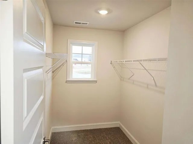 an empty room with a empty space and windows