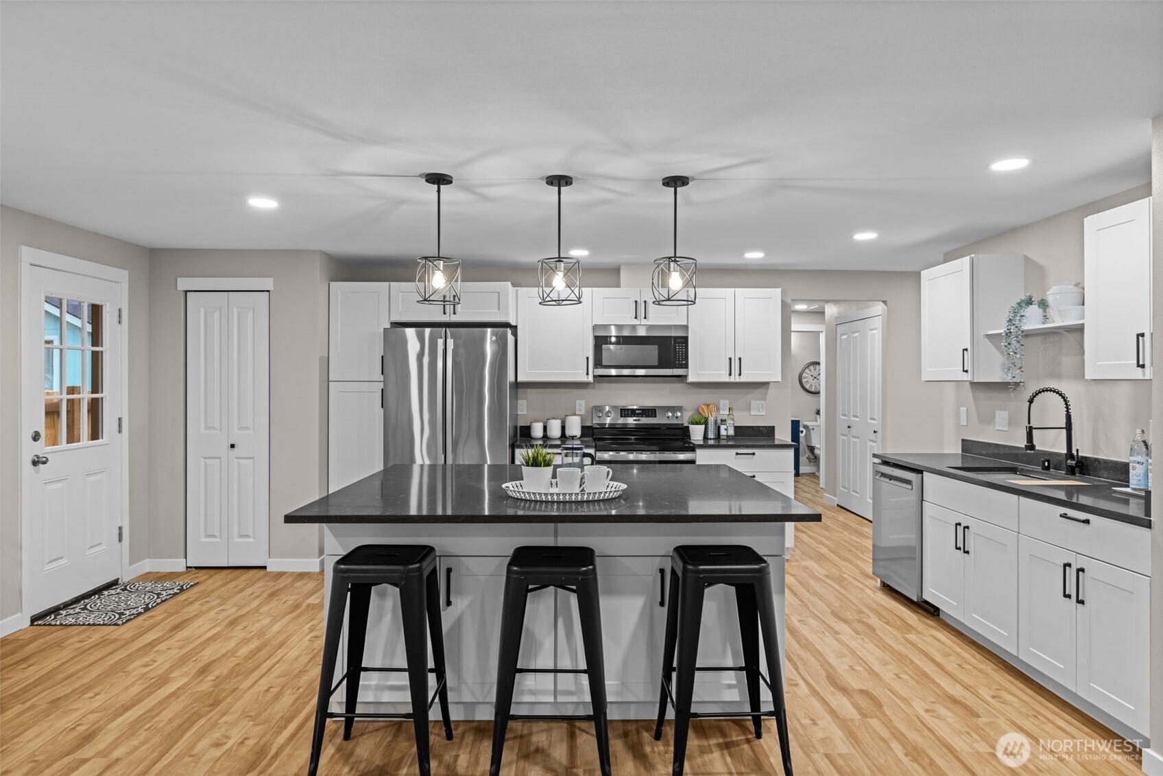 211 Taylor Street Snohomish, WA 98290 - Photo 5 of 24 a kitchen with stainless steel appliances granite countertop a kitchen island hardwood floor sink and stove