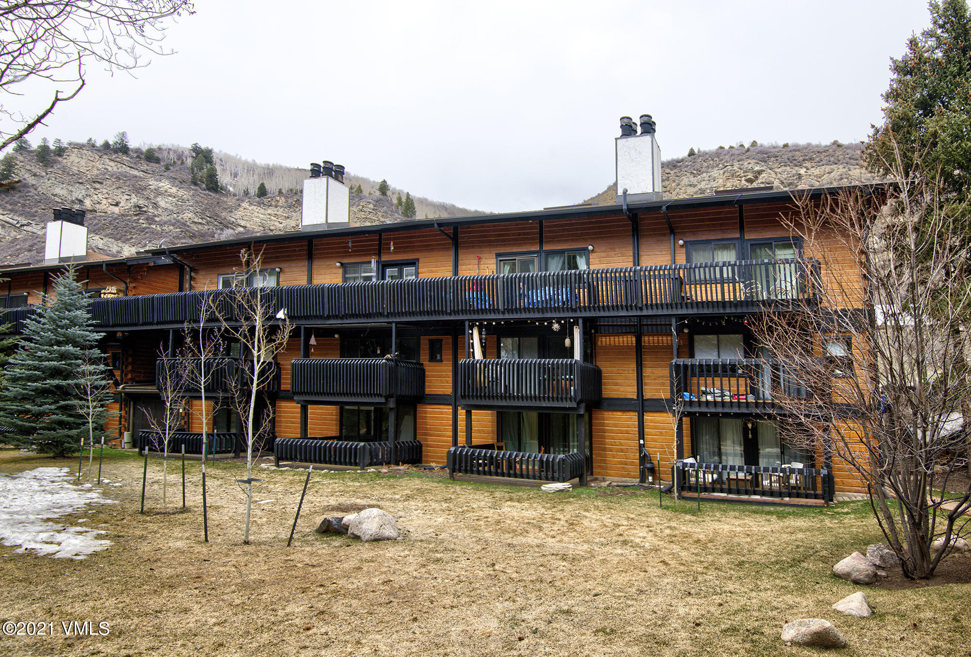 2958 South Frontage Road West, Unit D3 Vail, CO 81657 - Photo 22 of 23 a front view of a house with a yard