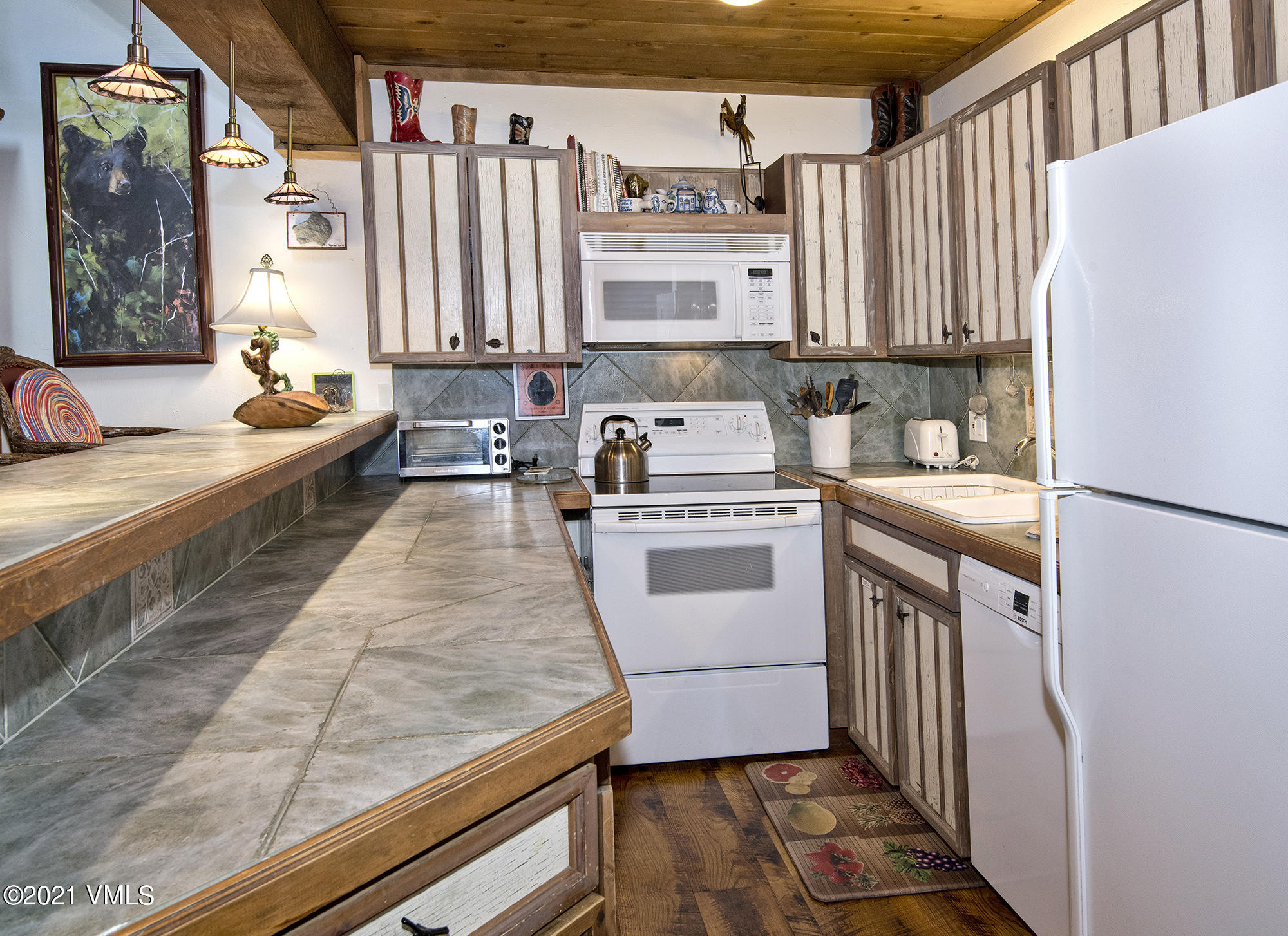 2958 South Frontage Road West, Unit D3 Vail, CO 81657 - Photo 5 of 23 a kitchen with a sink stove and cabinets