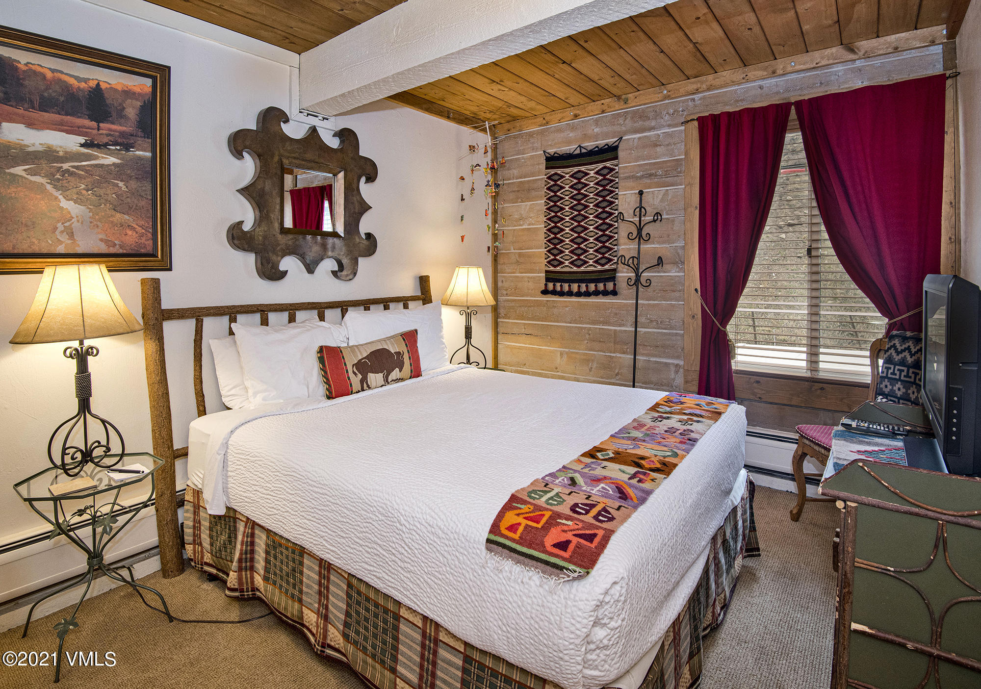 2958 South Frontage Road West, Unit D3 Vail, CO 81657 - Photo 10 of 23 a bed room with a bed and a table