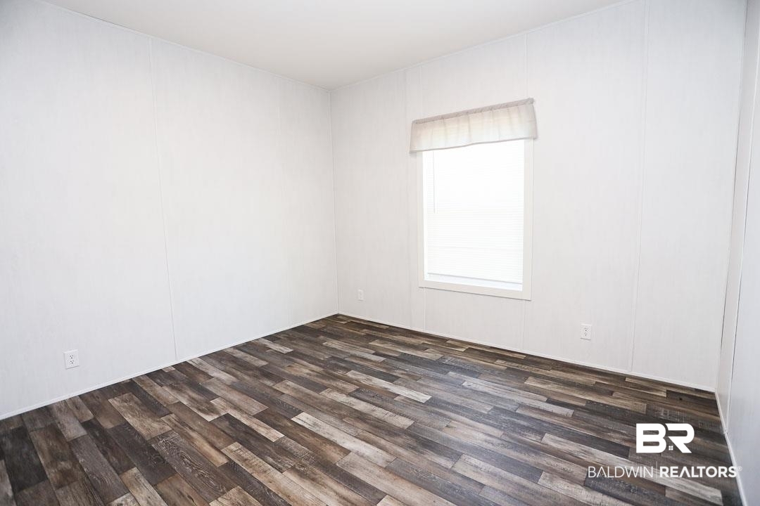 19180 Horseshoe Circle Seminole, AL 36574 - Photo 24 of 38 Spare room with dark wood-type flooring