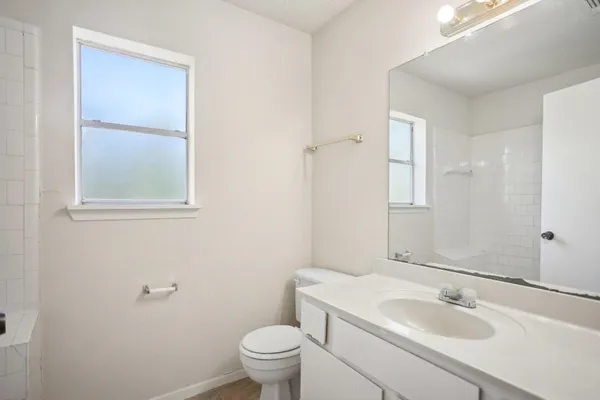 a bathroom with a sink toilet and vanity