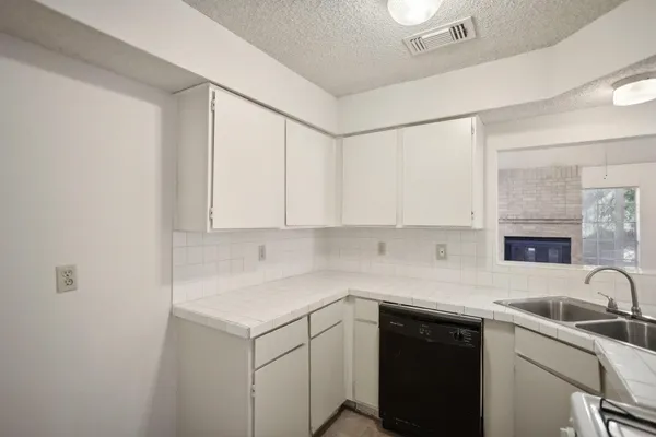 a kitchen with a sink cabinets and window