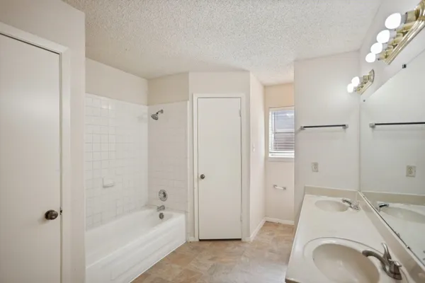 a spacious bathroom with a granite countertop sink a toilet and shower
