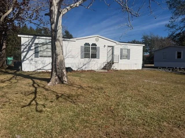 a house view with a backyard space