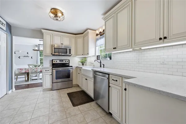 a kitchen with a sink cabinets and stainless steel appliances