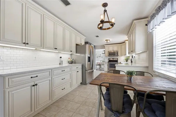 a kitchen with cabinets and window