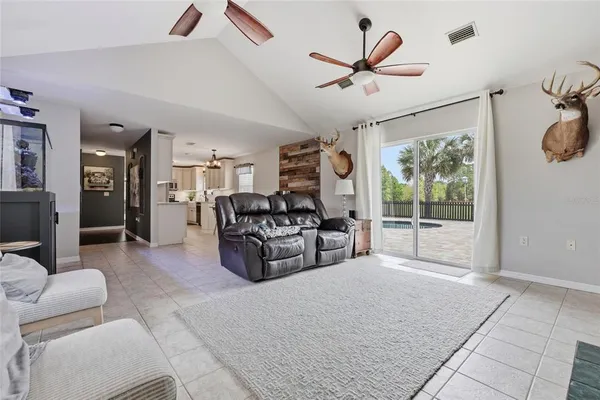 a living room with furniture a ceiling fan and a rug