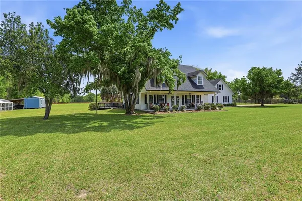 a view of house with outdoor space and garden