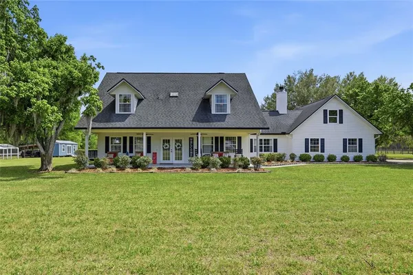 a front view of a house with a garden and porch