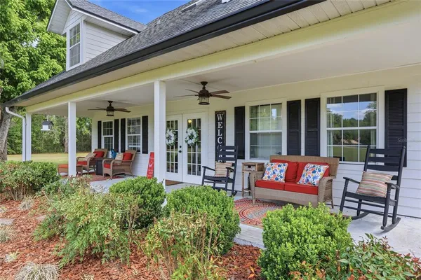 a view of a house with sitting area and garden