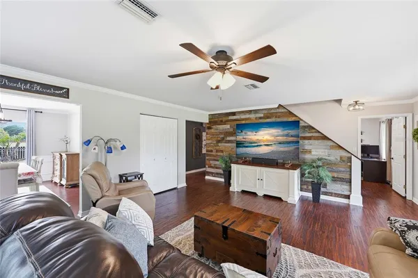 a living room with furniture and a wooden floor