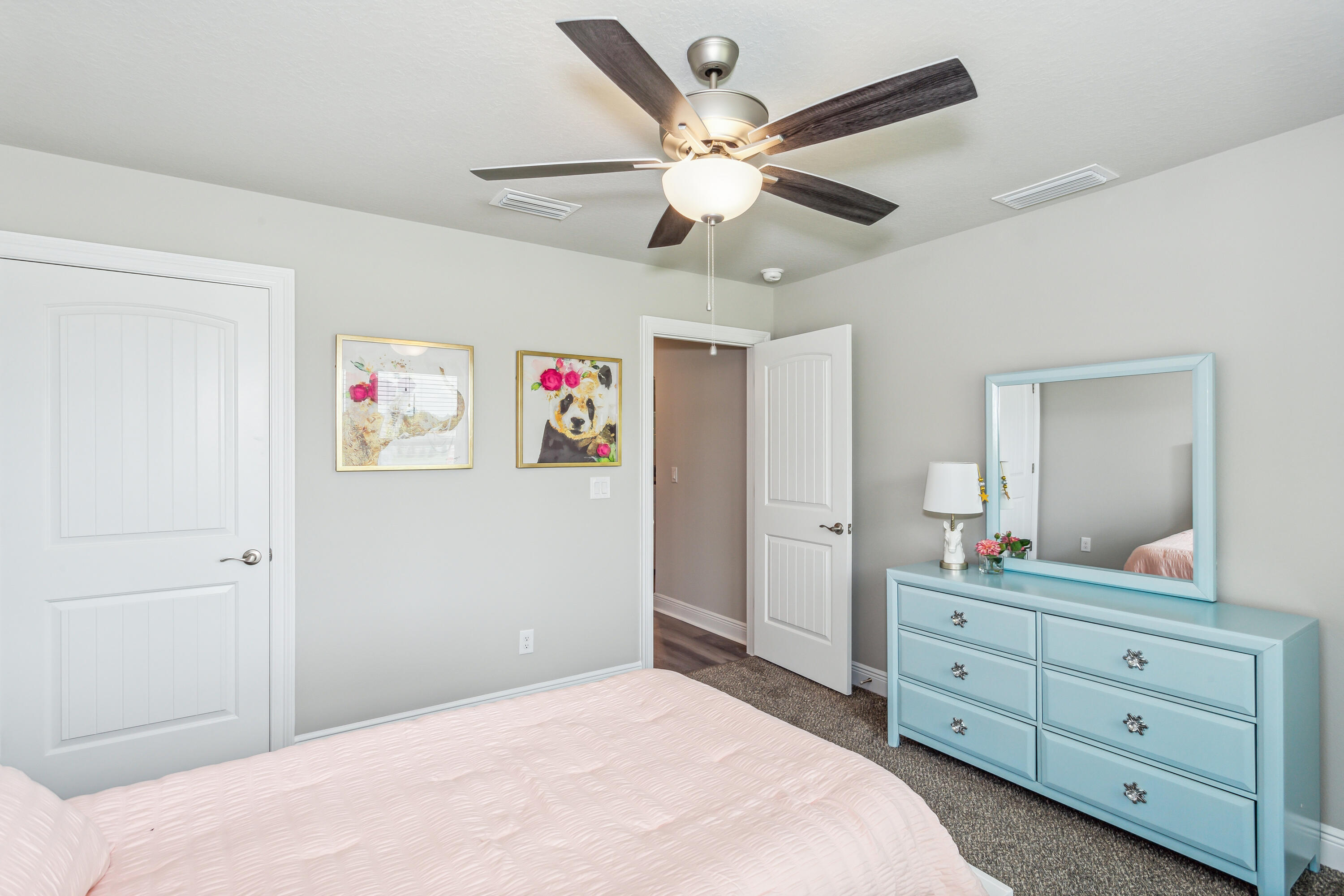 8721 Valhalla Drive Milton, FL 32583 - Photo 36 of 48 a bedroom with a bed and a chandelier