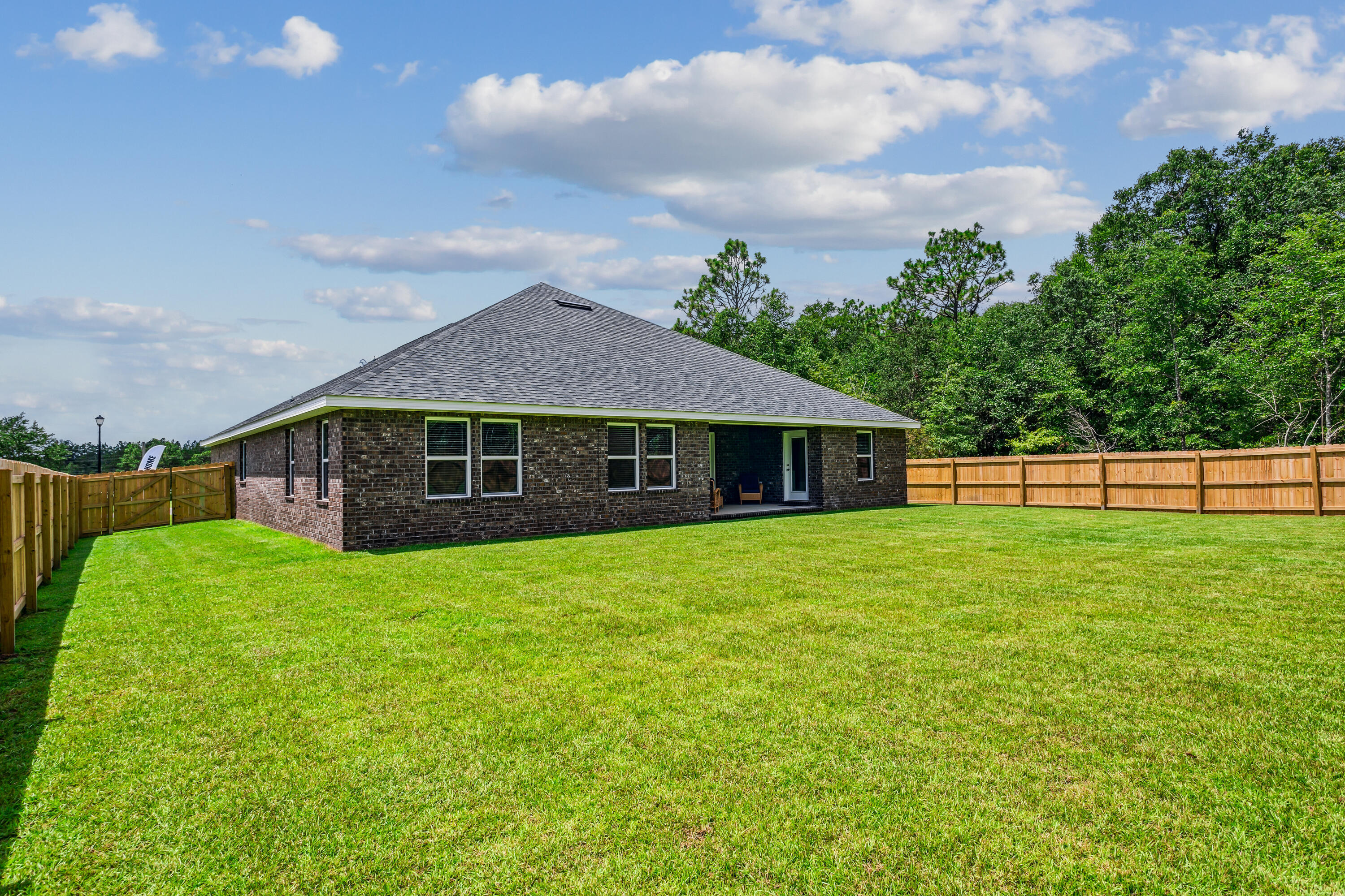 8721 Valhalla Drive Milton, FL 32583 - Photo 45 of 48 a front view of a house with a garden
