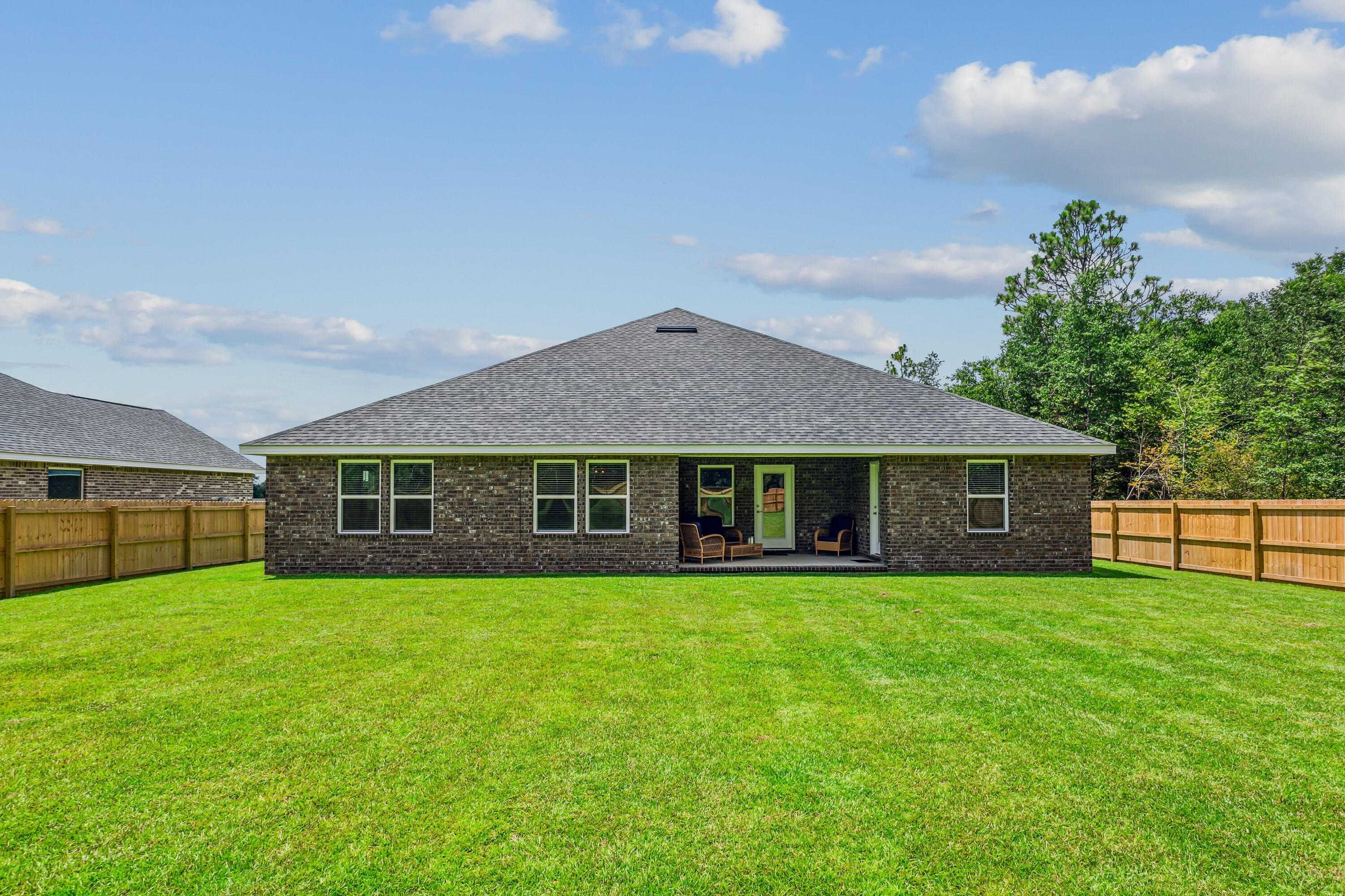 8721 Valhalla Drive Milton, FL 32583 - Photo 46 of 48 a view of a house with a yard and large trees