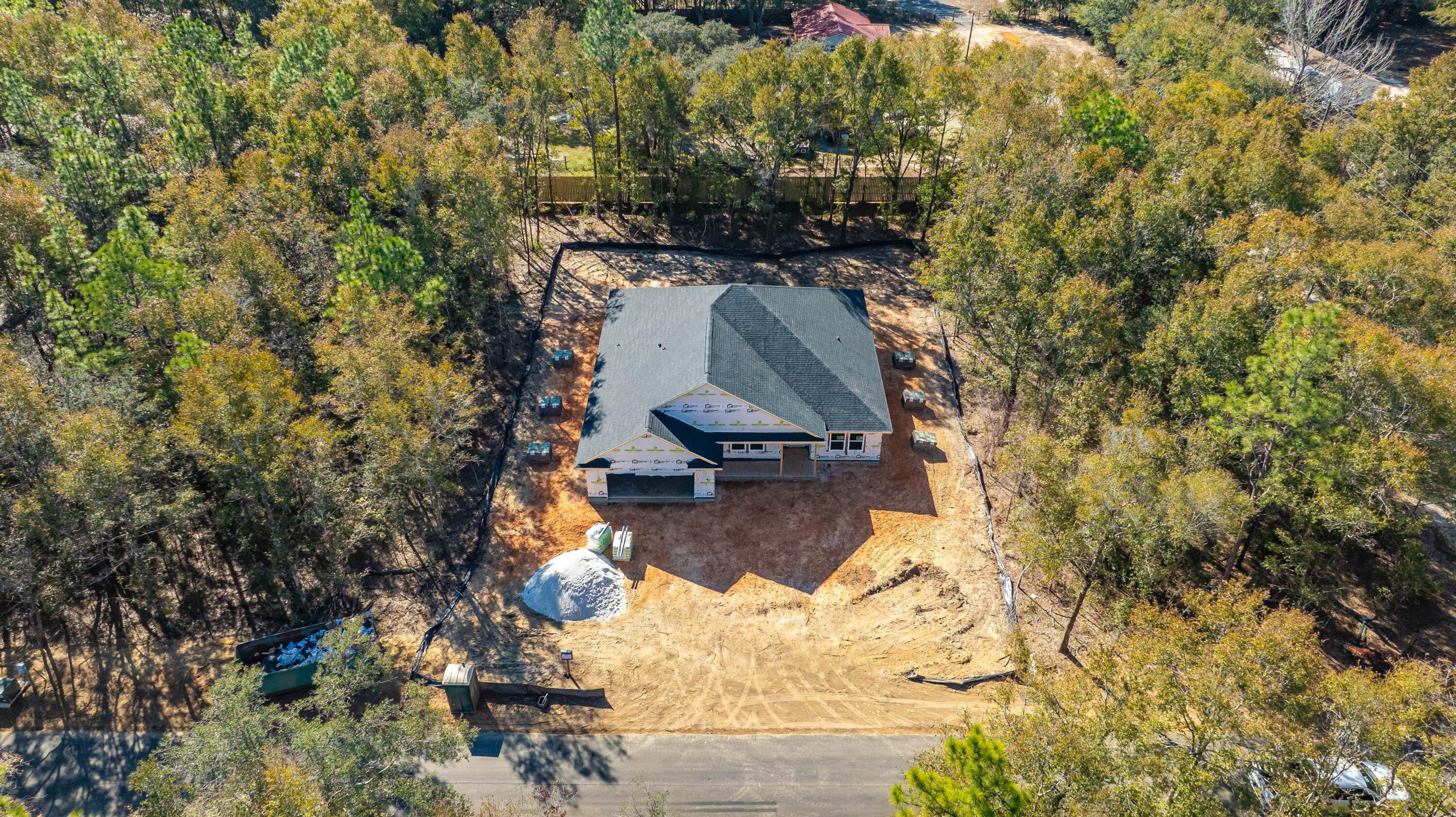 8721 Valhalla Drive Milton, FL 32583 - Photo 9 of 48 an aerial view of a house with a yard and large trees