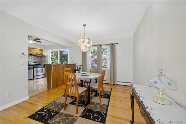 a view of a dining room with furniture a chandelier and wooden floor