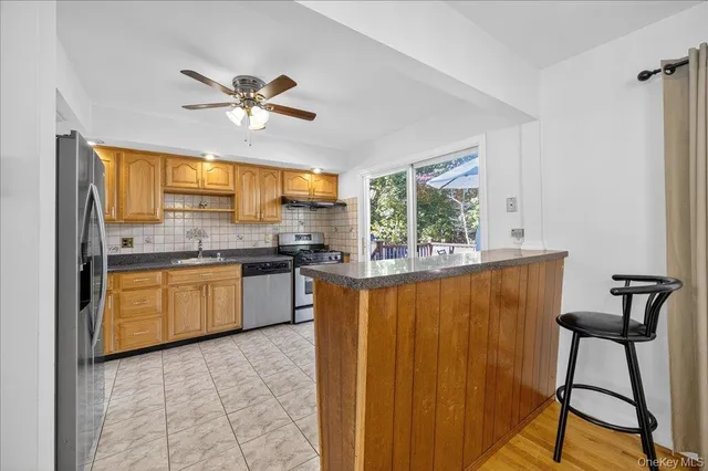 a kitchen with granite countertop a sink cabinets and appliances