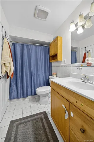 a bathroom with a sink a toilet and mirror