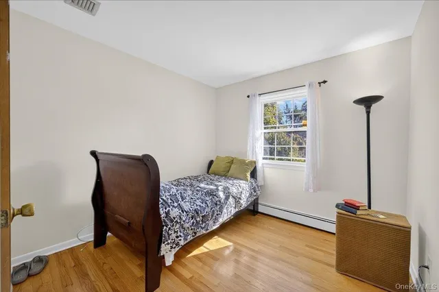a bedroom with furniture and a window