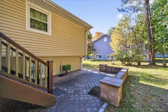 a view of a house with backyard and sitting area