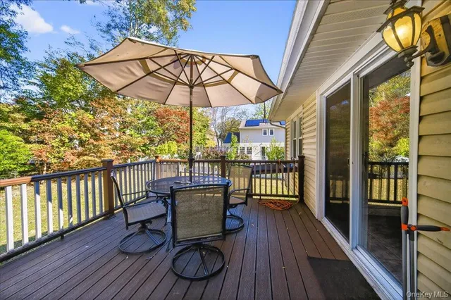 a view of a balcony with furniture and wooden floor