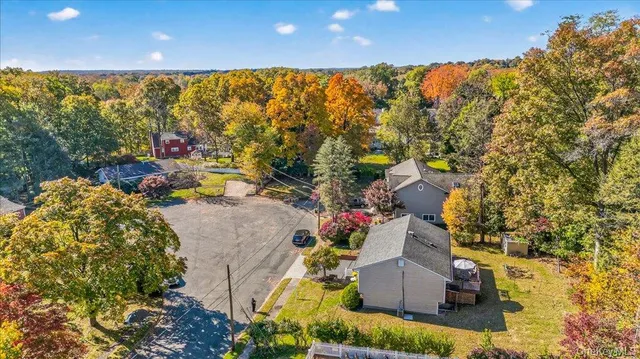 an aerial view of a house with a yard and lake view