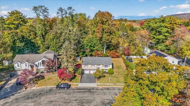 an aerial view of a house with a yard and garden