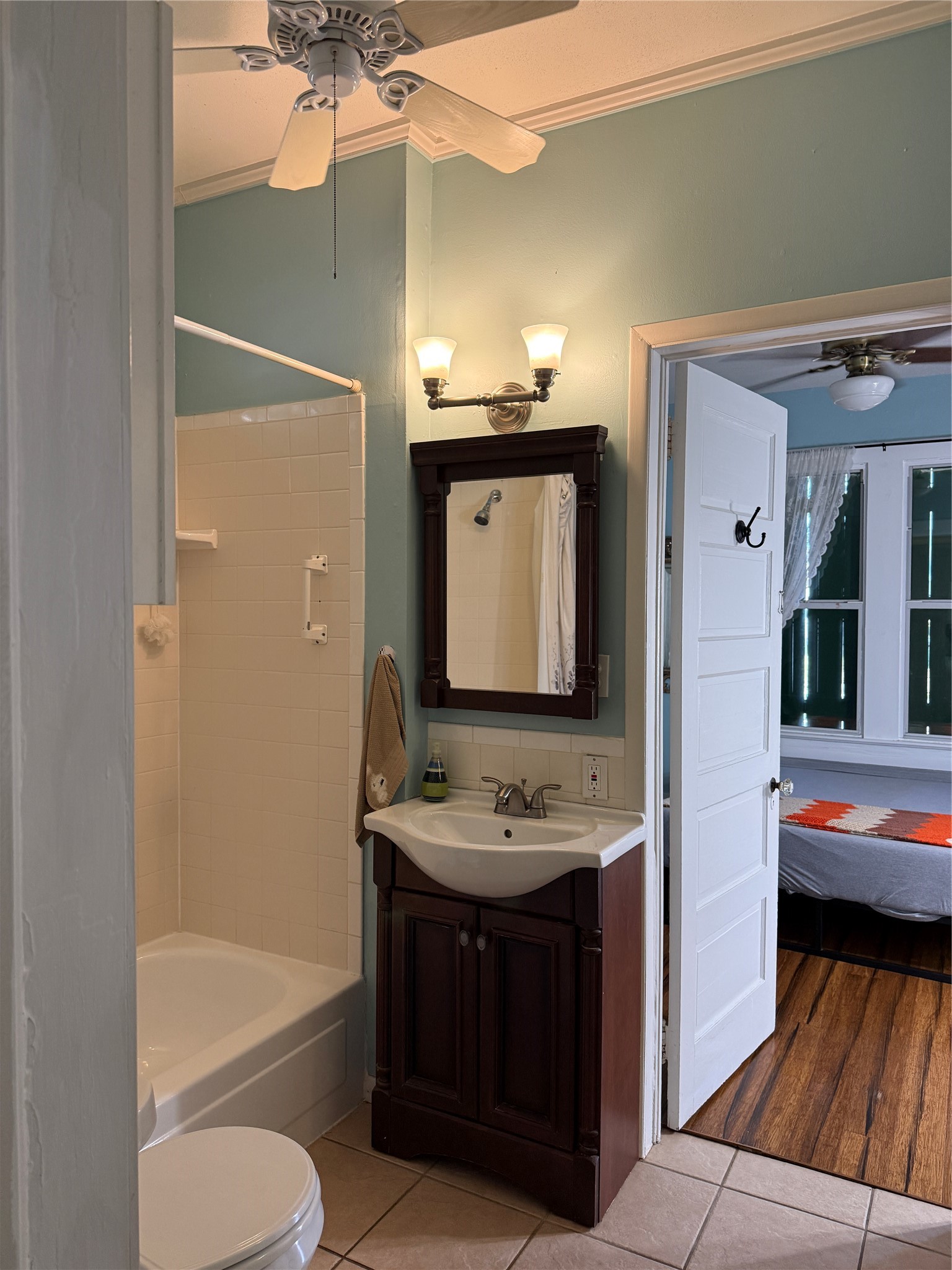 4416 Avenue R Galveston, TX 77550 - Photo 4 of 11 a bathroom with a tub sink and mirror