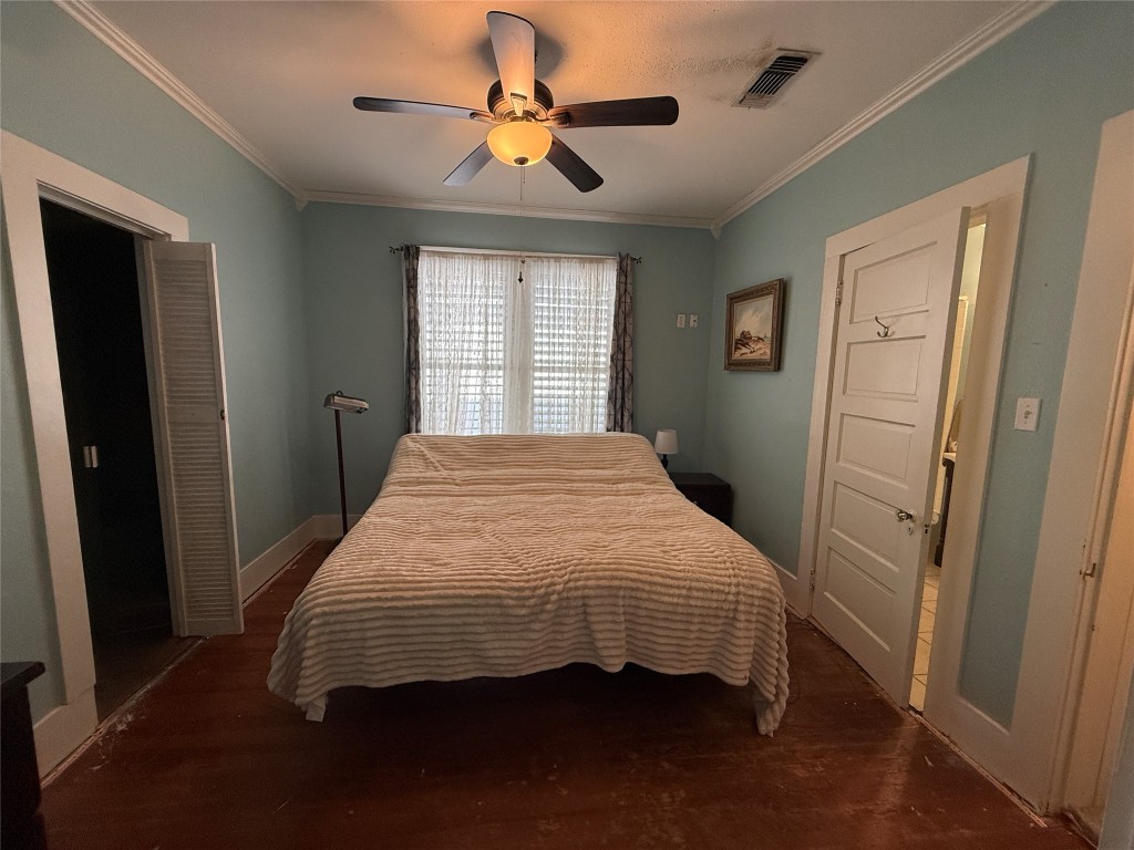 4416 Avenue R Galveston, TX 77550 - Photo 5 of 11 a bedroom with a bed and a chandelier