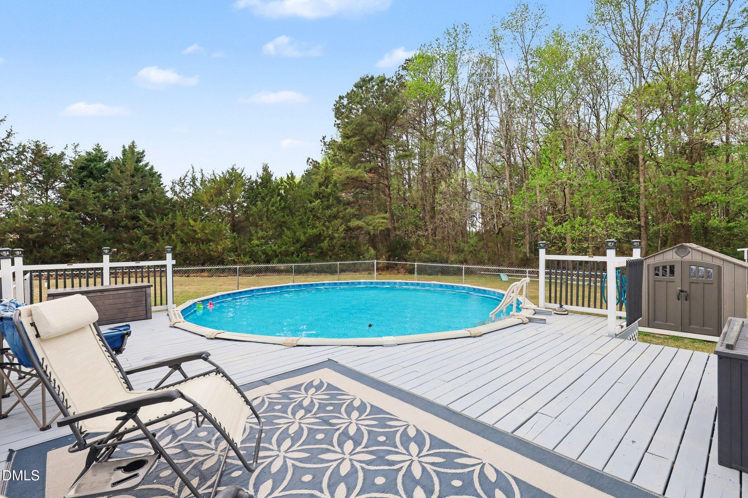 430 Fred Hall Road Stedman, NC 28391 - Photo 43 of 63 a view of a swimming pool with a lounge chair