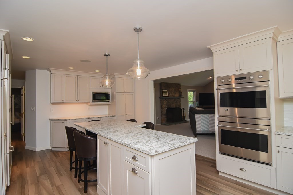 73 Cynthia Road Needham, MA 02494 - Photo 3 of 41 a kitchen with stainless steel appliances granite countertop a kitchen island a stove and a refrigerator