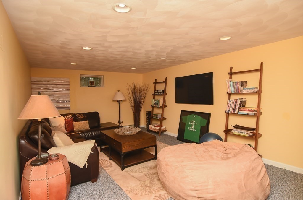 73 Cynthia Road Needham, MA 02494 - Photo 35 of 41 a living room with furniture and a flat screen tv